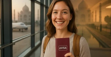 A smiling traveler at an airport holding her India eVisa to india, document with the Taj Mahal visible in the background